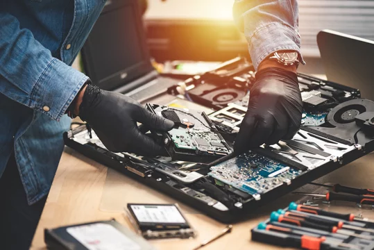 Technician repairing a laptop computer